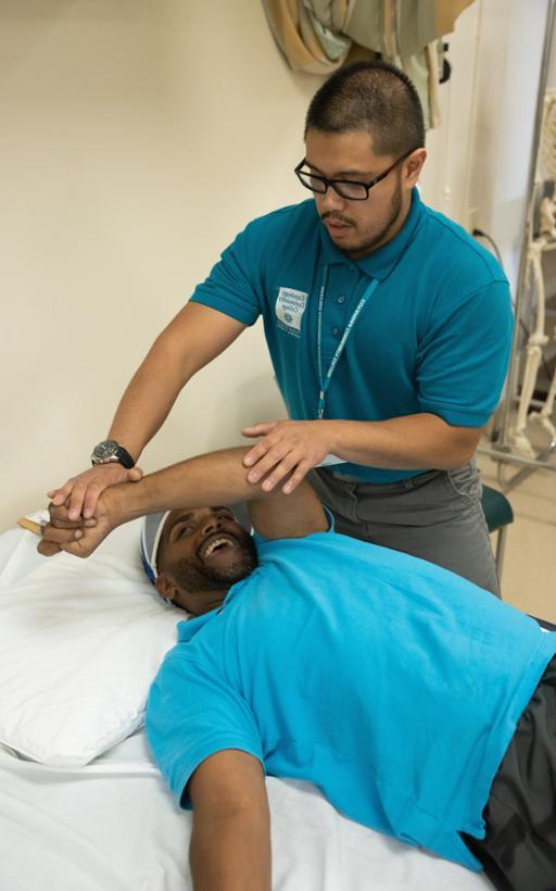 Tri-C student working with a client at the Preventative Care Center