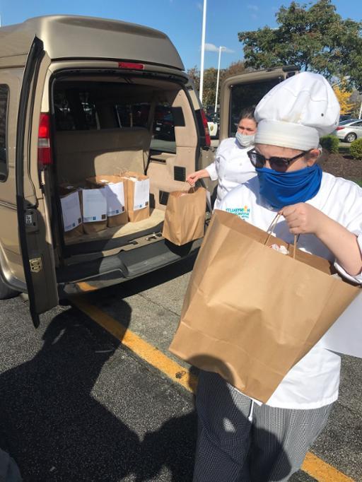 Tri-C students unloading food from a van for delivery at Lutheran Hospital