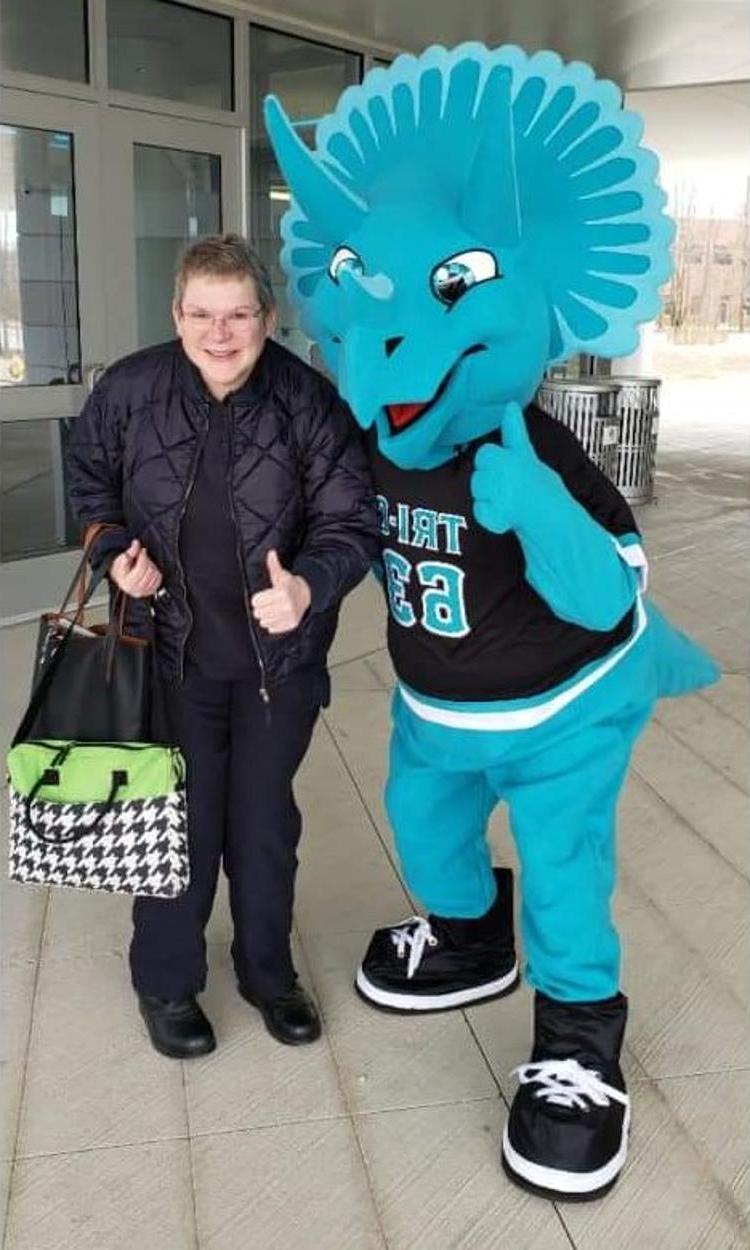 photo of student and Tri-C mascot